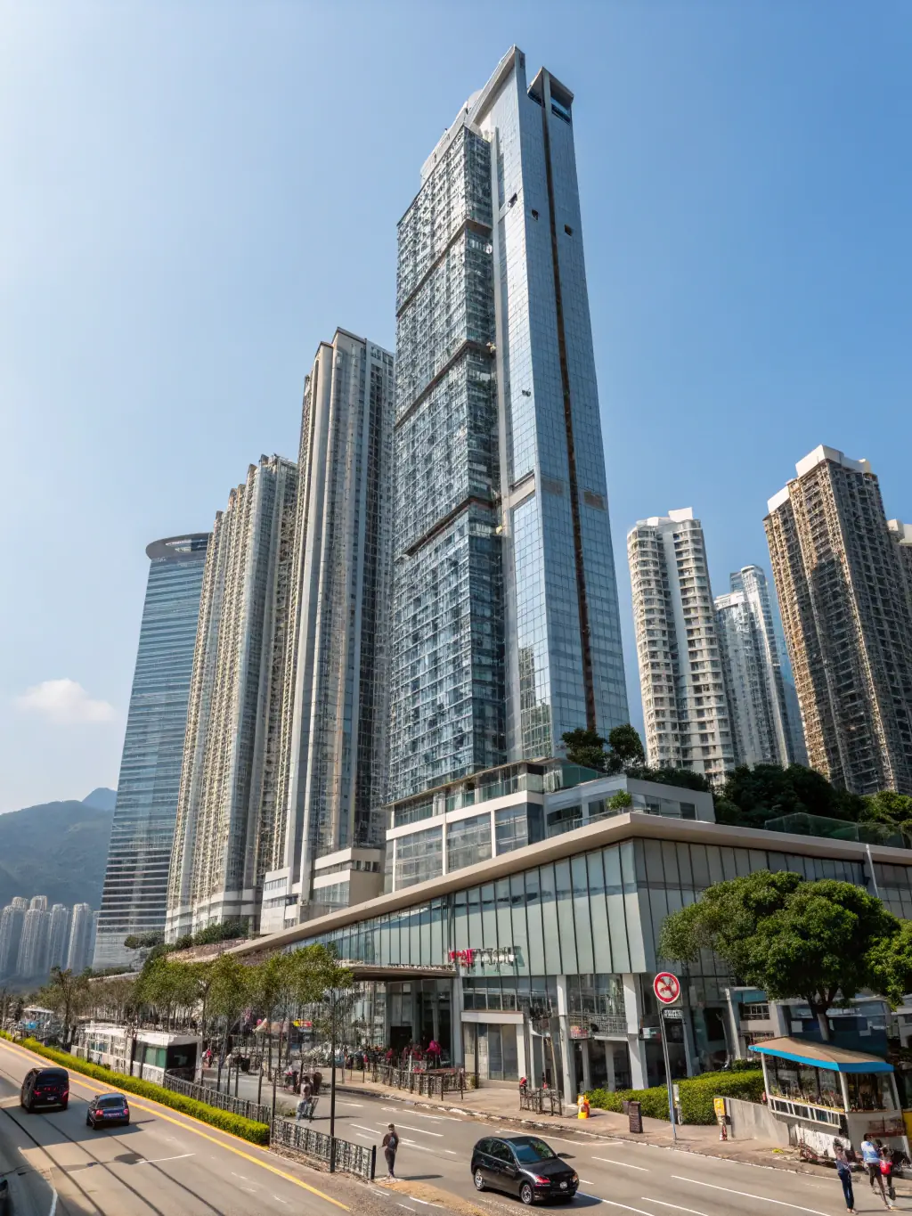 An image of new residential developments in Kennedy Town, Hong Kong, with construction cranes in the background.